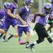 Pioneer High School football players run a drill during the first day of practice on Monday, August 12, 2013. Melanie Maxwell | AnnArbor.com